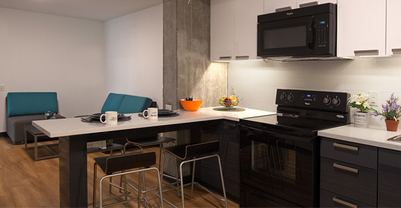 Kitchen and common area in Centennial Place suite